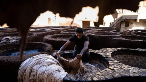 Ugur Yildirim/Getty Images At the Shuvvara Tannery, which is the lifeblood of the leather tanning craft in Morocco, leather has been colored using traditional methods for centuries on 18 June.