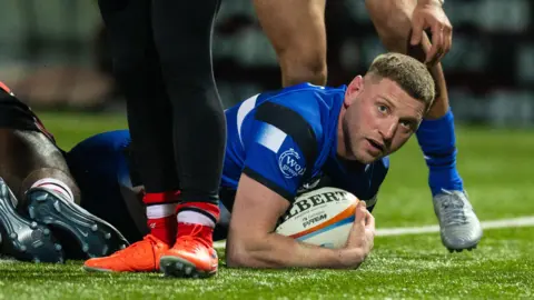 Finn Russell lies on the floor over the try line