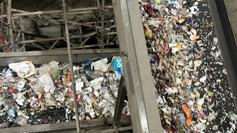 BBC Two conveyor belts of rubbish going one over the other