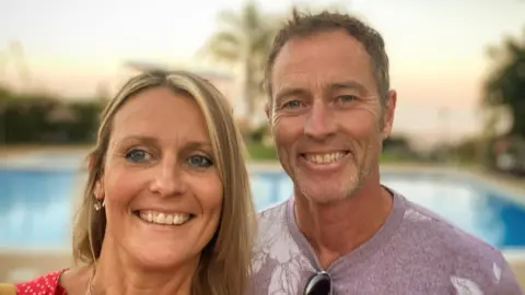 Foreign Office Image of Lindsay Foreman (left) and Craig Foreman (right) smiling as they pose together for a selfie picture.