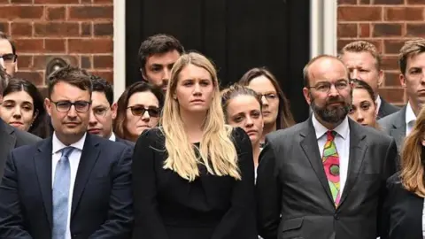 Getty Images Charlotte Owen standing in Downing Street with allies of Boris Johnson as he announced his resignation