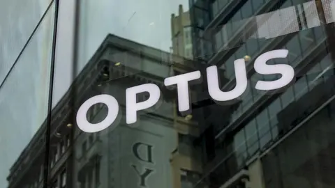 Getty Images An illuminated signage at an Optus store in Sydney, Australia