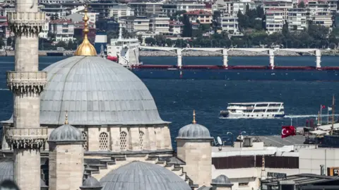 EPA Istanbul skyline with dome of an Ottoman mosque in foreground. Vessels can be seen on the Bosphorus waters with multi-storey houses on the other bank in the backdrop.