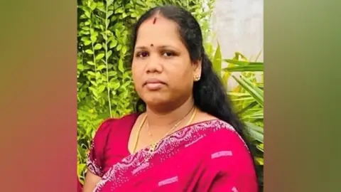 Handout Nilani Nimalarajah has long black hair and is wearing a pink dress