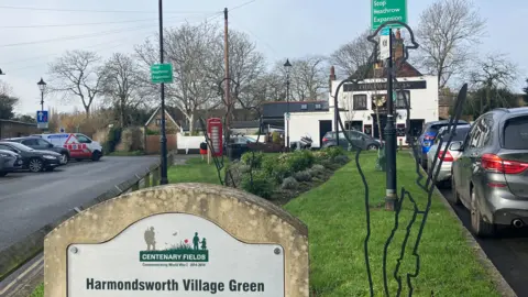 Harmondsworth Village Green with stop Heathrow expansion signs