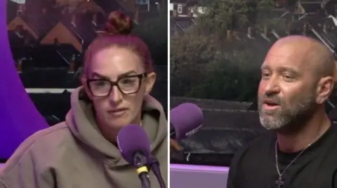 Stephanie (left) and Zacc Hancock are sitting in the studio at BBC Radio Stoke. They have purple microphones in front of them. Stephanie is wearing a grey hoodie and glasses and has her tied up in a bun. Zacc has a shaved head and a greying beard. He is wearing a cross on a chain round his neck and a black top.
