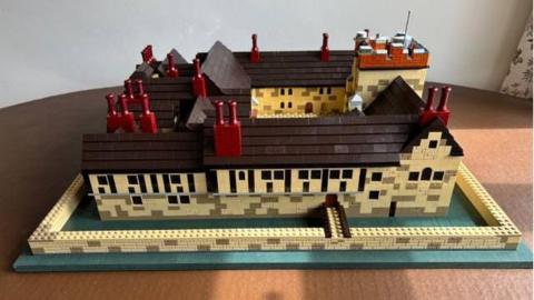 A Lego model of Ightham Mote complete with walls, bridges and a moat 