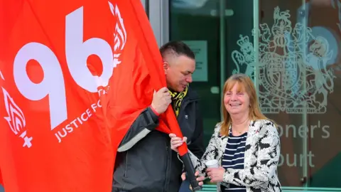 Getty Images Margaret Aspinall smiling with a fellow campaigner outside the coroner's court in 2016 