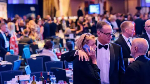Guests talk to one another in the dining room following a shooting incident during the annual White House Correspondents’ Association dinner in Washington