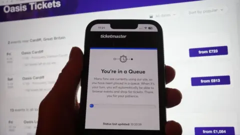 PA Media Picture of website selling tickets for Oasis gigs - showing queue for purchases 
