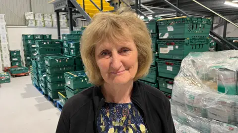 Phil Harrison/BBC Volunteer team leader Dianne Hill at the warehouse