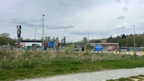 BBC/Owen Sennitt The view of the service station from the neighbouring field