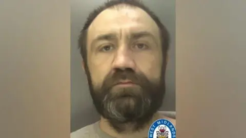 West Midlands Police Custody photo of middle-aged prisoner with dark beard