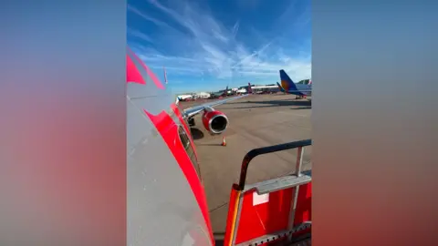 The side of a parked Jet2 plane on the runway at Birmingham Airport