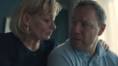 Netflix Christine tremarco with arms around Stephen Graham