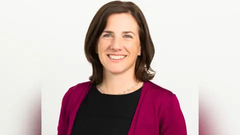 Clean Air Fund A headshot of Jane Burston, the founder and chief executive Officer of Clean Air Fund. Jane is wearing a dark pink cardigan and black t-shirt. She has shoulder length dark brown hair.