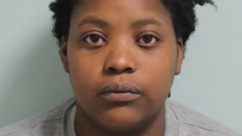 Metropolitan Police Police mugshot of Deveca Rose. She is staring at the camera and is wearing a grey sweatshirt