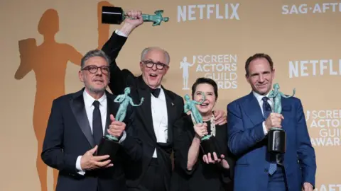 Sergio Castellitto, John Lithgow, Isabella Rossellini and Ralph Fiennes, winners of the Outstanding Performance by a Cast in a Motion Picture award for "Conclave," pose in the press room during the 31st Screen Actors Guild Awards at Shrine Auditorium and Expo Hall in Los Angeles.