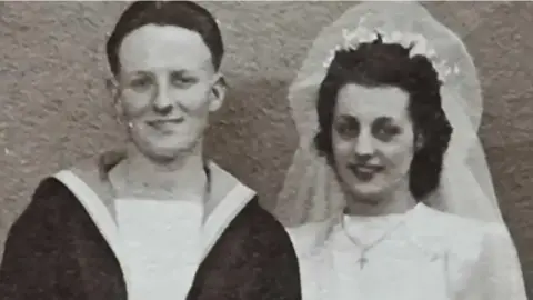 Black and white photo of Mr Bartlett in his naval uniform and his wife in a wedding dress