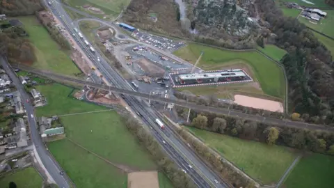 Network Rail An aerial view of a railway bridge crossing a motorway. 
