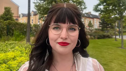 Felicity Zimmermann with glasses and brown hair at Anfield