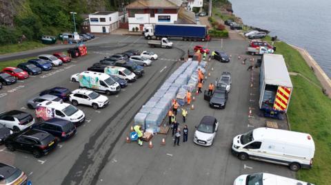 A drone photo showing people collecting bottles of water in Brixham