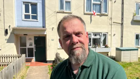 JOZEF HALL/BBC Darren Easton outside his Ekin Road flat