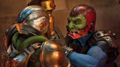 Samuel C Wilson as evil cyborg, Trap Jaw. He is wearing green makeup, prosthetics and armour