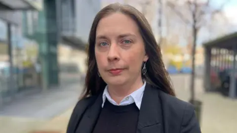 Dr Delma Childers, she has long dark hair and is looking at the camera.