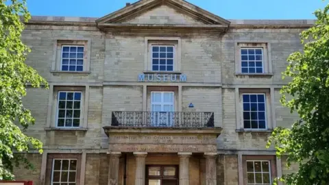 Front of Peterborough museum, a large Georgian building with "Museum" written on it in capital letters.