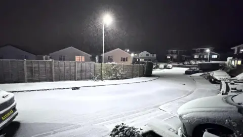 Emma / BBC Weather Watchers Snow covering a residential road in Pontypridd, Wales