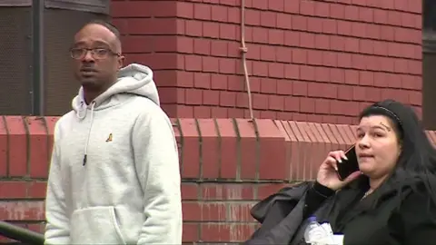 Two people on the steps of Leicester Crown Court