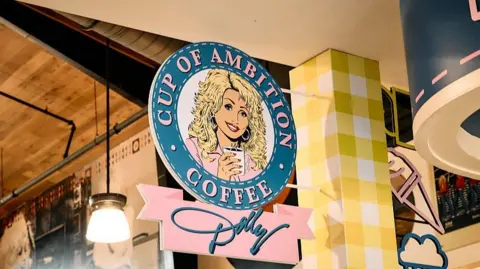 Diana King for The Washington Post via Getty Images Detail of the signage for Cup of Ambition Coffee inside Dolly's Tennessean Travel Stop in Cornersville, Tennesseee