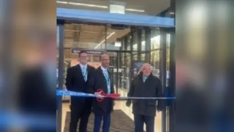 Facebook/David Thomas An image of David Thomas cutting a ribbon outside a Lidl in Cwmbran.