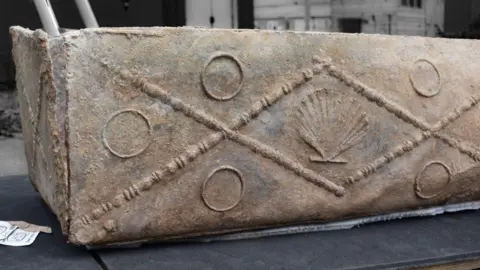 Colchester Archaeological Trust The lead coffin is decorated with a shell and circles embossed on it.