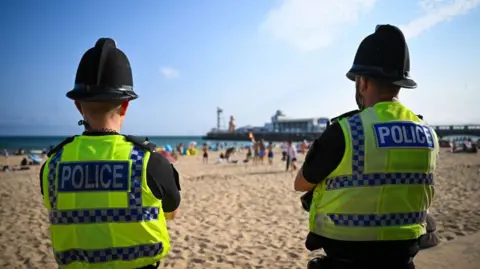 Getty Images Dorset Police officers patrol Bournemouth beach