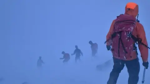 Rescuers in blizzard conditions.