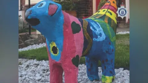 Cheshire Constabulary A view of the multicoloured painted Superlambanana sculpture from the front