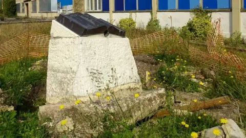 Linda De Santiz The war memorial engraved with the names of 102 employees who died fighting in World War One and World War Two left uprooted at the site of the former Cooper Tire and Rubber Company factory.