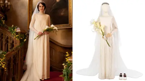 Carnival Films/Bonhams A montage of two photographs - one shows Michelle Dockery as Lady Mary wearing the wedding dress in the Downton Abbey series. The other is a studio shot of the same dress on a stand. In the first photo, Lady Mary is standing half way up a flight of stairs holding a bunch of lilies. The long straight white dress has long sleeves and a train which is draped down the stairs.
