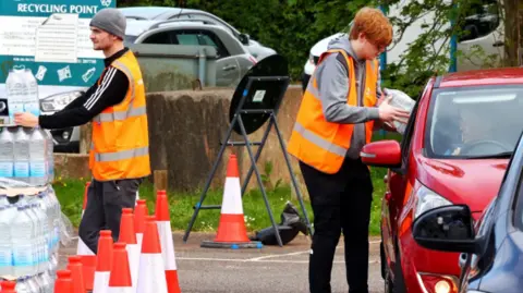 Alamy Handing out bottled water