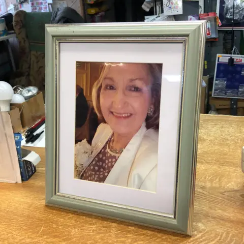 BBC / Naj Modak A photo of Maureen Stroughair on the shop counter