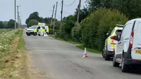 Police vehicles at the scene of the incident in May