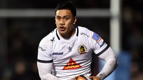 Len Ikitau runs with the ball in both hands held down to his left hip during a match for Exeter