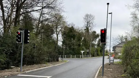 Leicestershire County Council Traffic lights, new tarmac and road markings with house on one corner