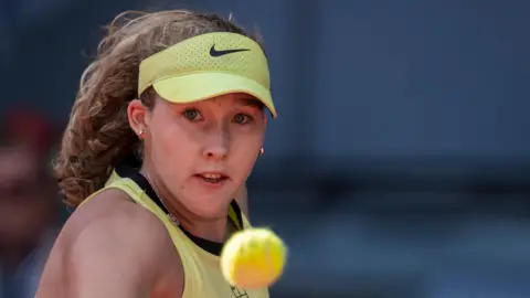 Mirra Andreeva playing a shot