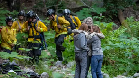 SVL Steve Photo of missing hiker hugging his family after he was found