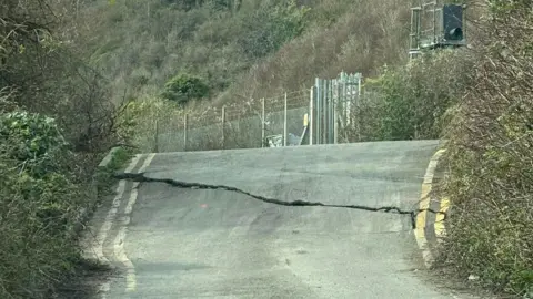 Khloe West Huge crack stretches across width of road at Folkestone Warren