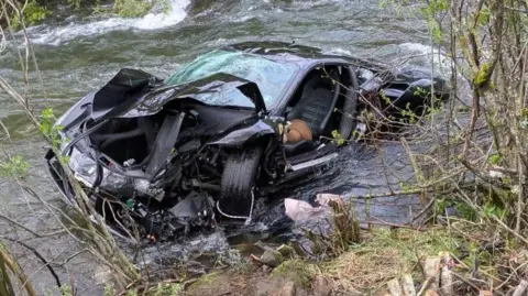 The wreckage of a sports car car that was found plunged into a river in Northern Spain on Sunday