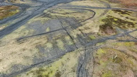 Vehicle marks at a coal tip